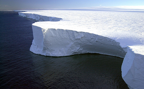 Large white ice sheet next to ocean